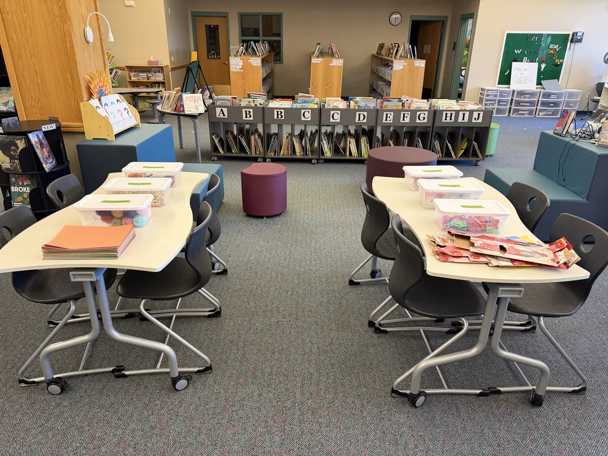 The Wilmot library set up for AI Club, with supply bins on two tables